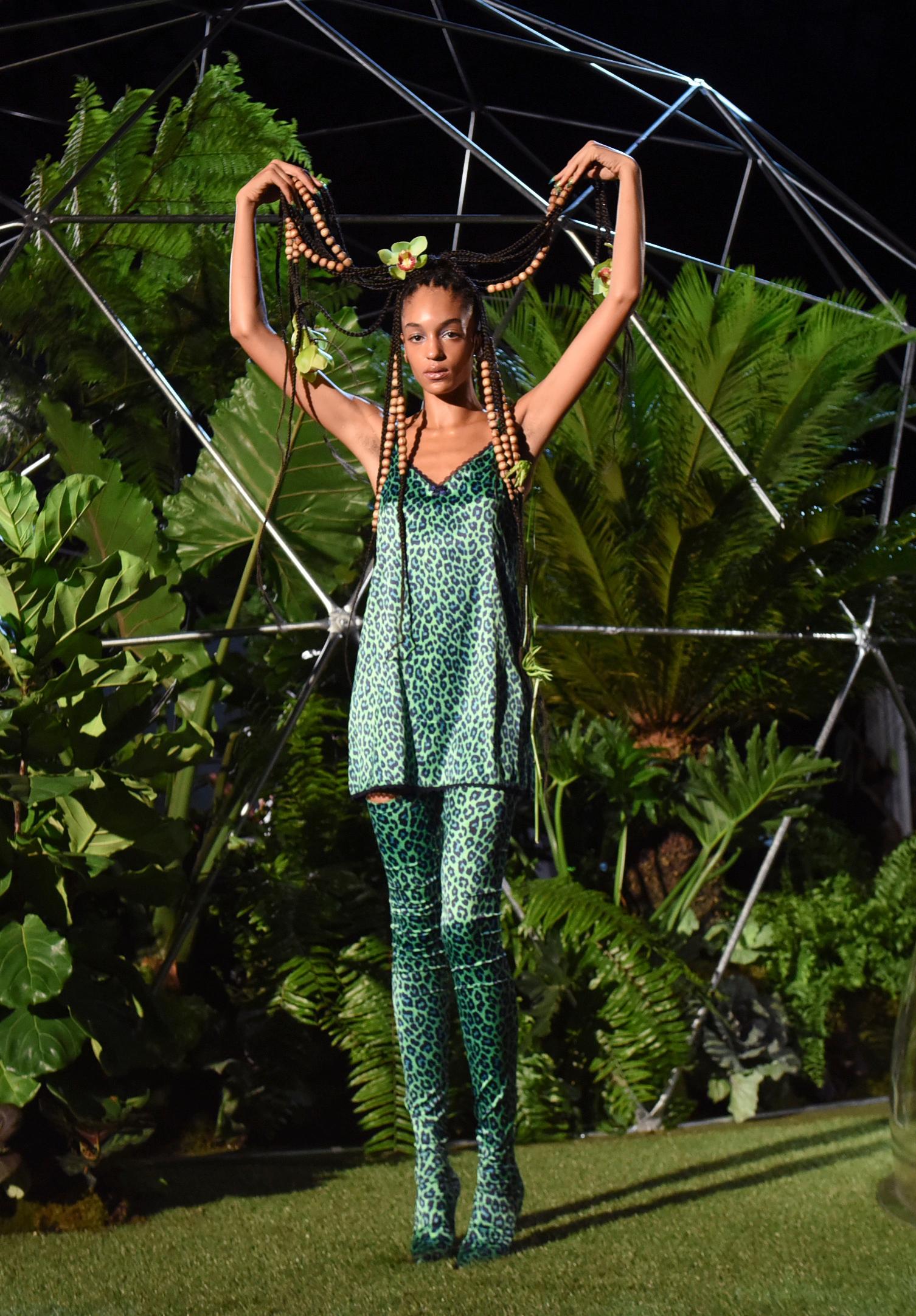 savage x fenty fashions are modeled for photographers before a